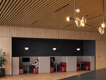 Hassell chose SAS740 linear metal ceilings in a bespoke WoodTones dye-sublimation finish