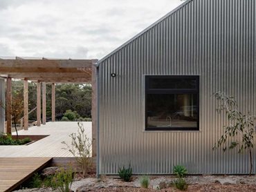 The communal deck between the two pavilions - the houses are wrapped in a robust galvanised steel external envelope 