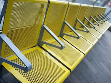 Detailed image of yellow public metal chairs with anti-corrosion coating
