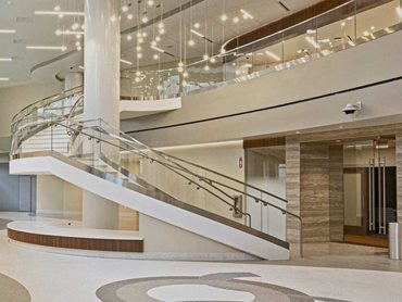 The bent glass installation provides a welcoming, light-filled environment and safe access point to The Woodlands Medical Center