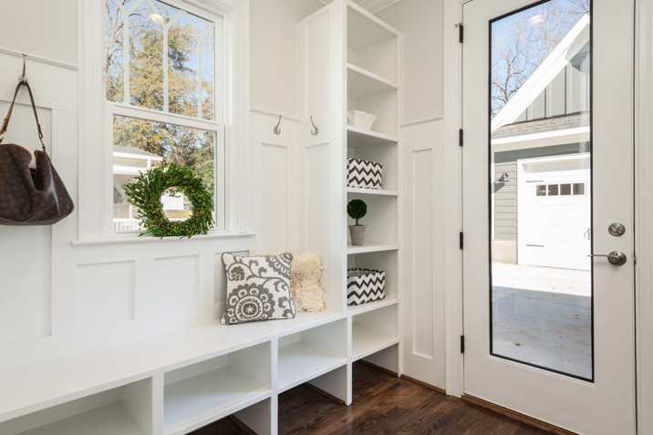 White mudroom suburbian street with empty shelves and lots of storage