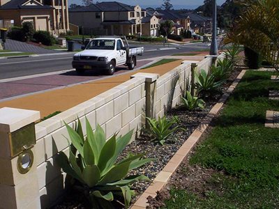 Roadside image of concrete masonry fence