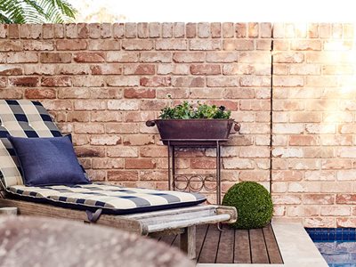 back yard furniture reclaimed brick wall