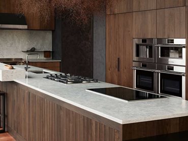 Appliances finished in high-grade stainless steel pick up the kitchen's natural tones