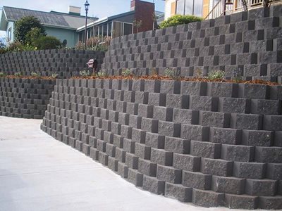 Outdoor image of grey retaining wall with small garden bed