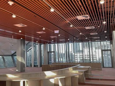 The red slatted finish of the ceiling inspires social connection and fosters cultural exchange