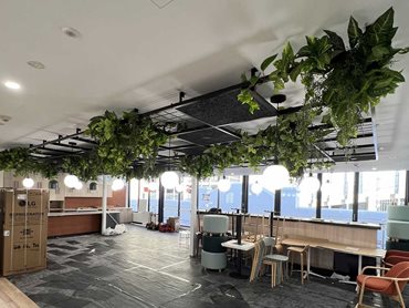 The scope involved installing artificial plants to Level 3 grid feature ceiling