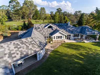 Aerial view of large residential home with concrete roof tiles 