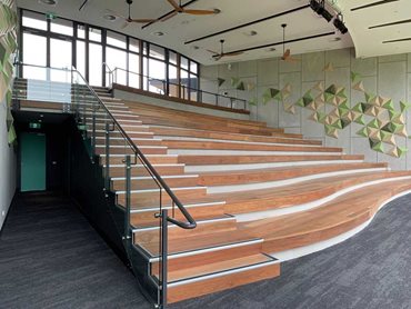 The tiered seating is bookended by walls clad with Cemintel Barestone complemented by acoustic tiles