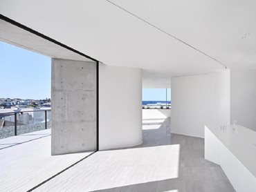 Alspec's balcony doors are offset against the angled walls, which direct sightlines to the beach