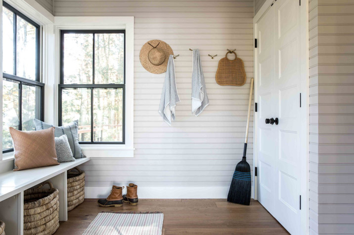 farmhouse suburban stylish mudroom with hangers and hooks storage and shoe space pillows aesthetic interior design