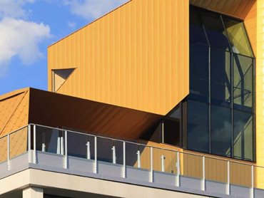 The new structure is expressed boldly with textured gold zinc cladding on all sides 