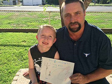 Kobie French (7) with father Alan French, RFS Tumbarumba Brigade Captain and his drawing