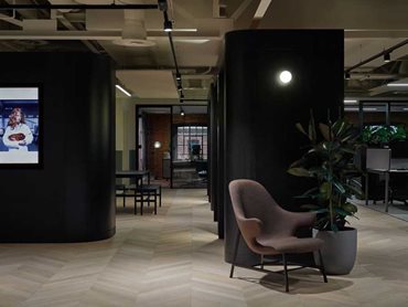 The Columba chevron flooring beautifully softens the interior, sitting exceptionally against the monolithic black stained oak elements of the joinery