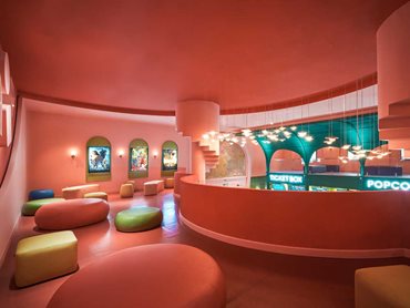 Circular and square shaped seats dot the mezzanine meeting area at Beta Cinema, inviting relaxation and connection