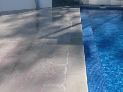 Grey tiled pavers next to swimming pool