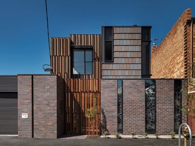 Exterior facade view of modern residential building with terracotta roof tiles 