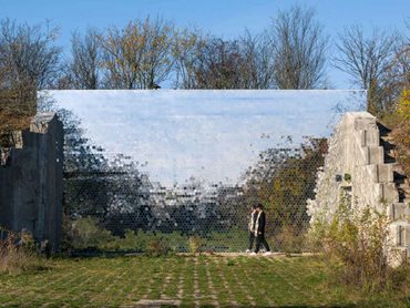 The captivating natural landscape is captured outside the bunker on a large mirror that reflects the bushes and trees. 