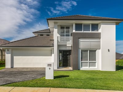 Exterior facade view of modern white and grey house with concrete roof tiles