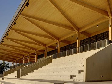 The glulam timber structure cantilevers for over 8 metres on top of the seating