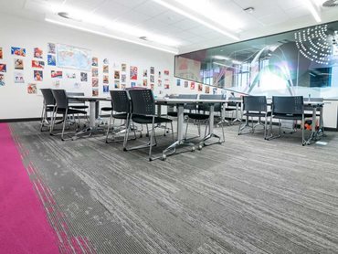 This solid pop of magenta on the floor was blended with Hyper Earth, a grey base tile featuring highlights of magenta, and Drifted Ground, a mixed grey tile to help balance the design