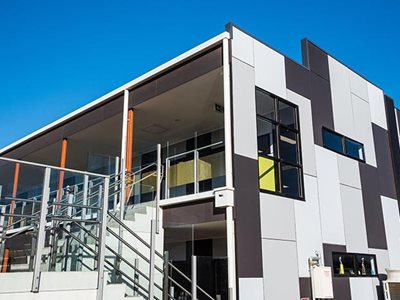 Exterior building facade with fibre reinforced cement cladding