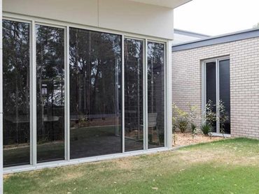 Purposefully well-shaded tall glazed facades made from Alspec aluminium framing 