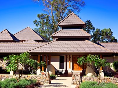 Exterior view modern Asian inspired home with terracotta roof tiles 