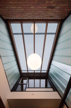 Channel glass atrium and skylight. Entry into Gezellig House. Photography by Trevor Mein