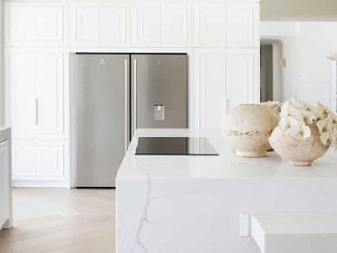 The island bench and Electrolux 501L Stainless Steel Refrigerator in the Three Birds-designed kitchen