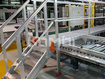 KOMBI’s stairs and crossover systems provide workers safe access over a complex conveyor belt system 