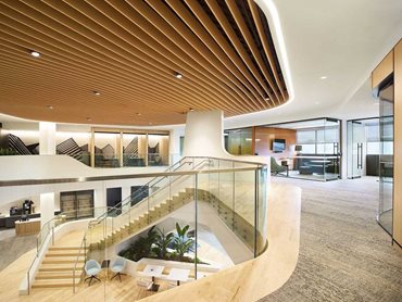 The glass clad staircase connects to the second level, and features an impressive open void