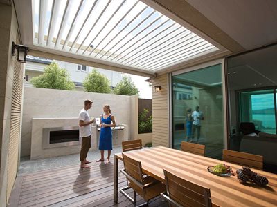 LouvreTec-White-Opening-Roof-Louvtres-on-Patio with Couple Holding Drinks and Chatting