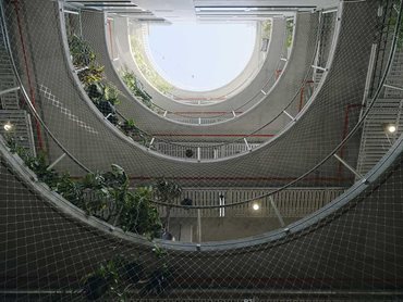 A landscaped, semi-circular void connects each level 