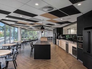 The staff breakout area showcases acoustic ceiling tiles from the ASONA Triton range along with ASONA Polyfon Mesh open-celled panels