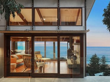 Stacker sliders open the house to suspended decks, offering panoramic ocean views
