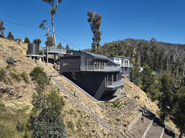 Solar power panels, heat pump hydronic and water heating, high level insulation and fire rated windows and shutters combined with careful materials and equipment selection, have all contributed to a sustainable, bushfire protected house on a hill.
