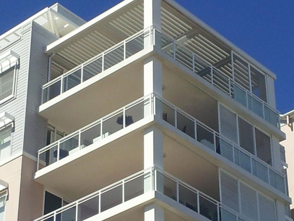 Outdoor living spaces on apartment balconies with a Vergola