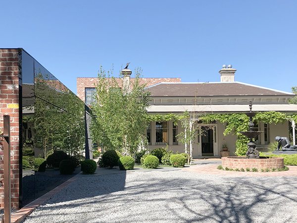 The extension is legible as distinct works while being sympathetic in scale to the original house. The new built form is understated when viewed from the street. The new north facing two-level extension has been located to the rear behind a brick garage and pool area partly over clad in black Perspex which mirrors the lush garden and the detailed Victorian façade in the distinctive large setback on approach to the front door.