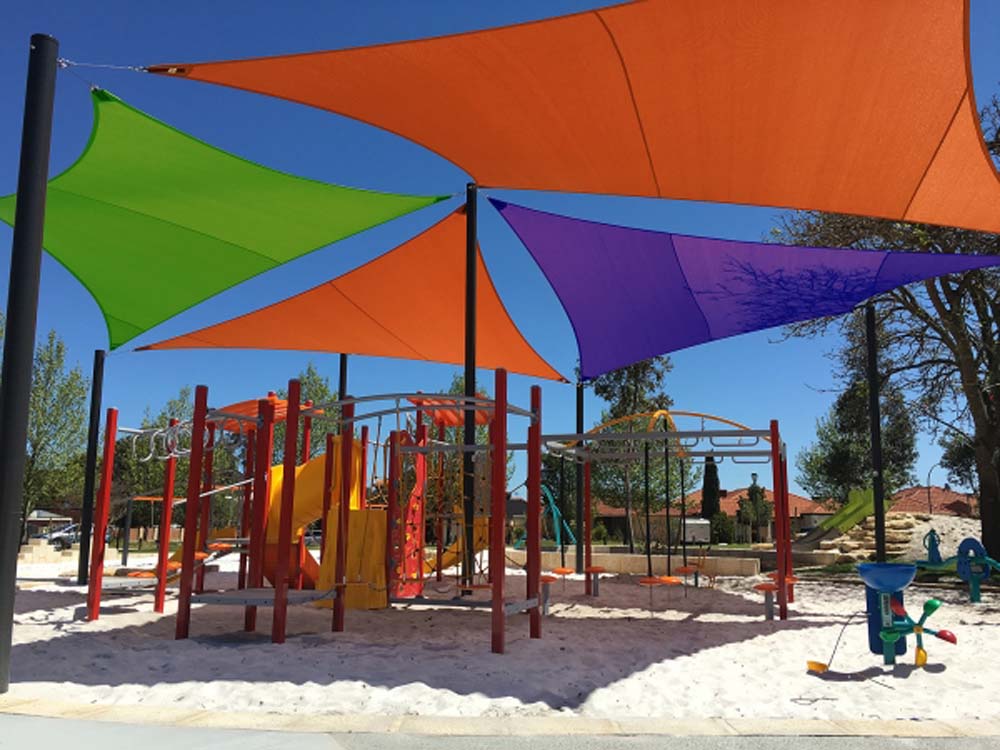 Kwel Court Playground featuring Bright Green, Orange and Royal Purple shade fabric