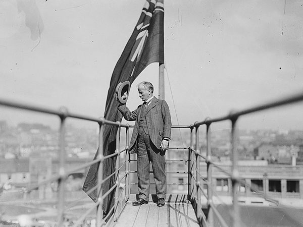 John Bradfield doffing his hat to the people below at the Sydney Harbour Bridge opening