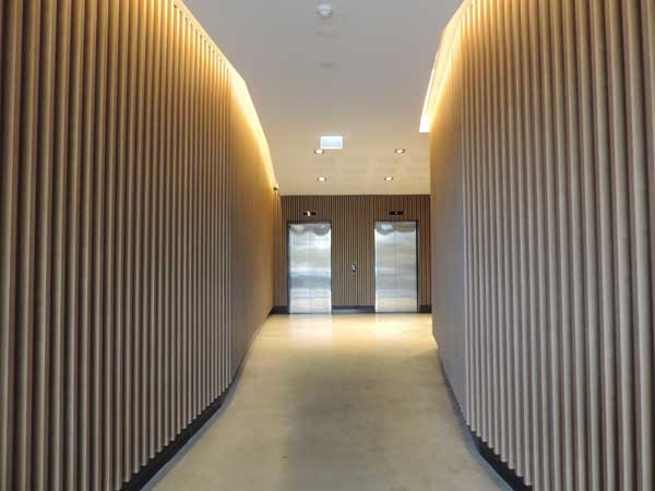 The entry lobby of Spectrum Apartments featuring Covet&rsquo;s Ever Artwood aluminium cladding system

