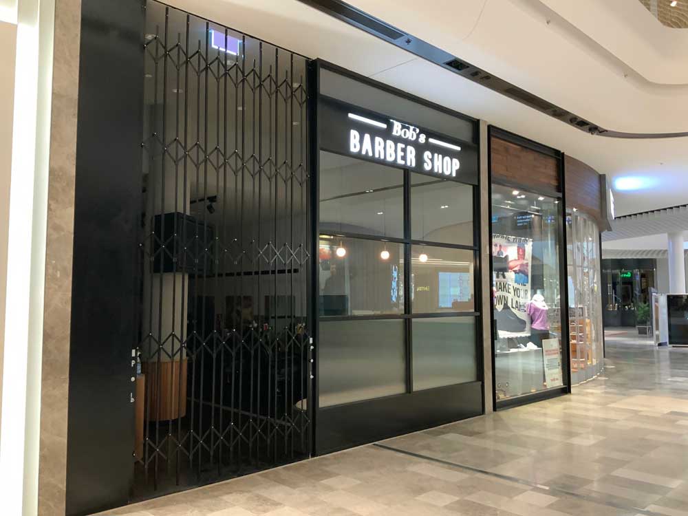 ATDC's 4500mm high commercial bifold security doors at Bobs Barber