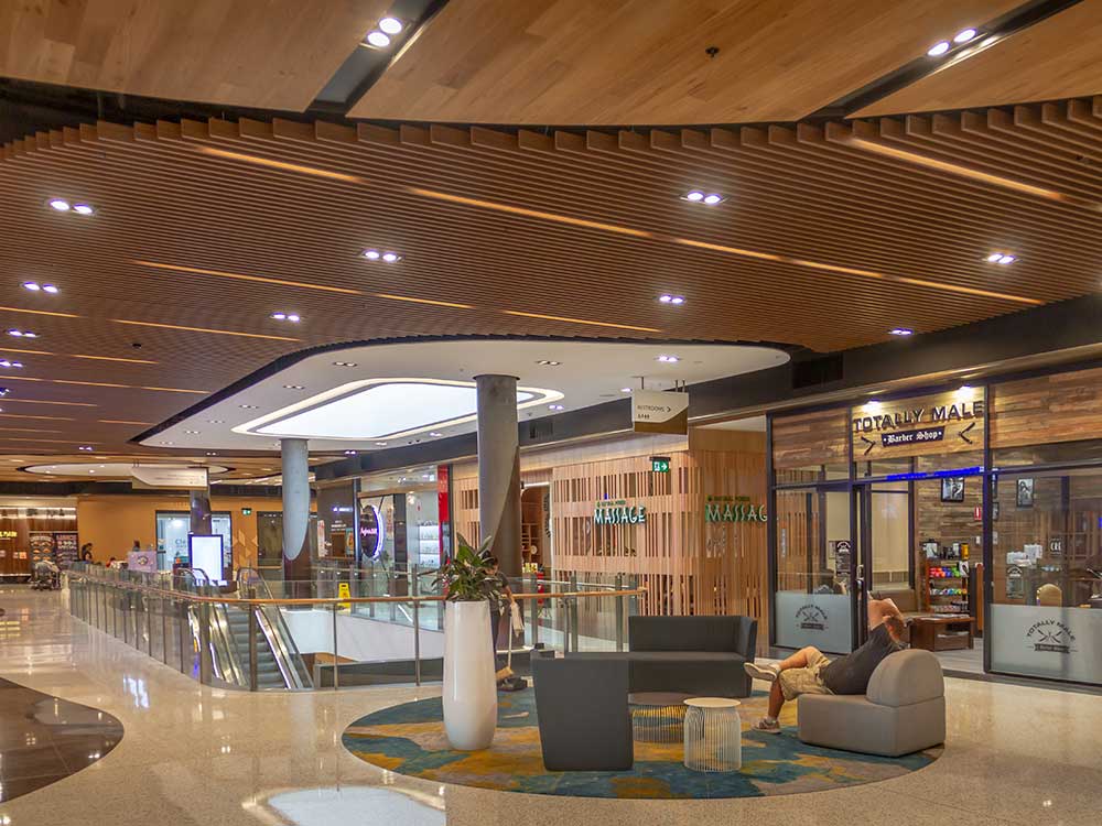 Interior view of retail center with MDF slat ceiling system
