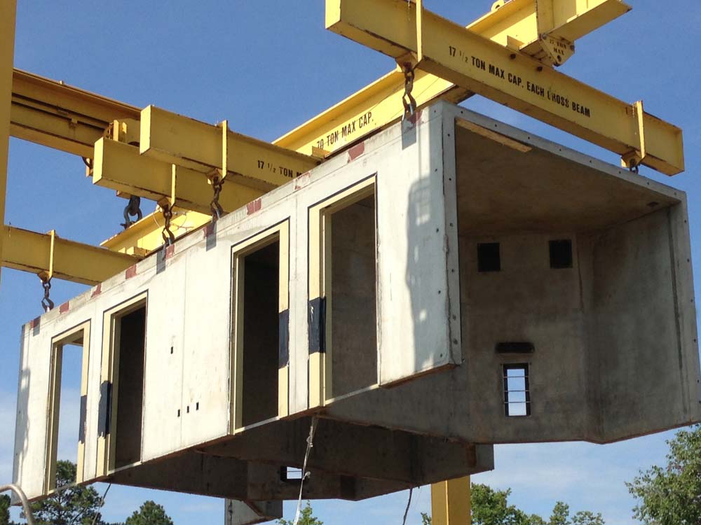 The modular units are stacked using tracked gantry cranes
