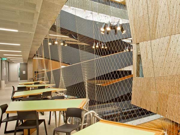 Over 1200m² of stainless steel mesh stretch the entire height and span of the five-storey atrium of the new University of Melbourne’s School of Design