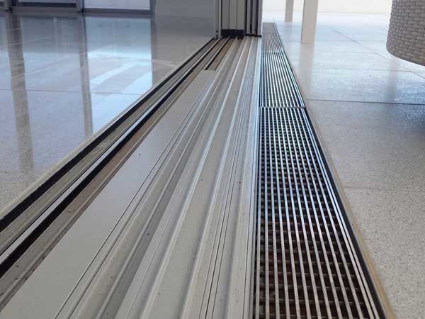 Level threshold drains provide a flat surface without running the risk of treading water indoors
