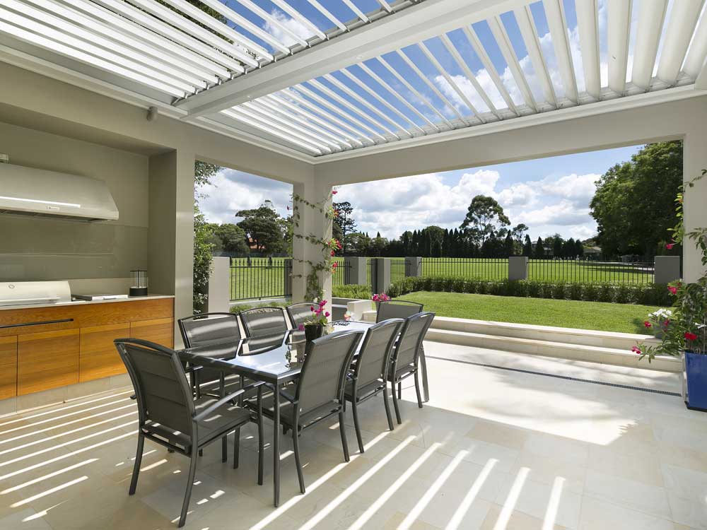 A patio with a Vergola opening and closing roof system