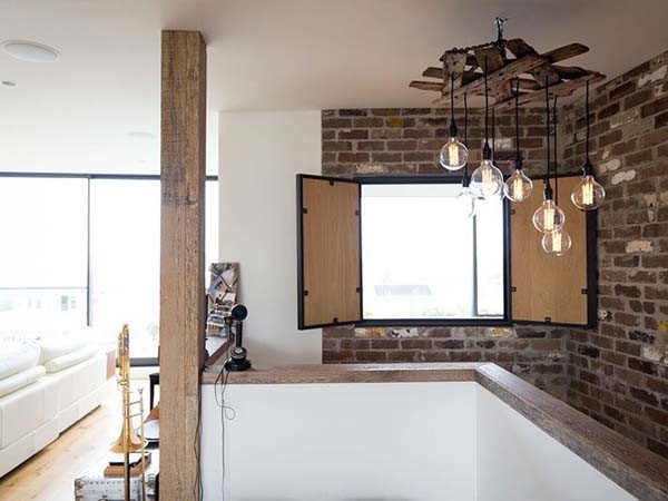 A steel post near the stairwell in the living room was seamlessly clad in Barn Oak
