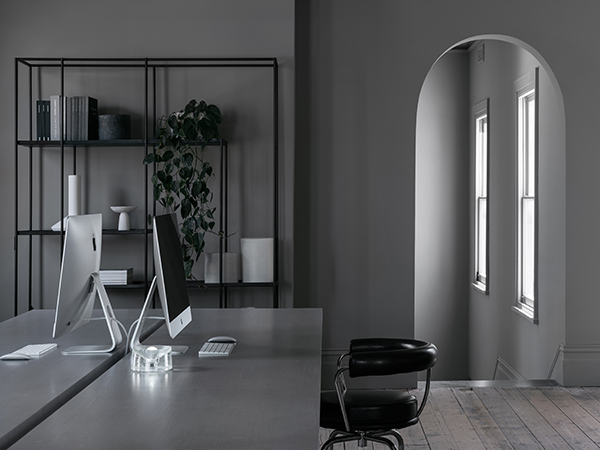 The purposeful layering of grey provides a soothing backdrop to the office, allowing a collection of custom pieces to be accentuated, including a five-metre long, timber-veneer desk purpose built in its place.